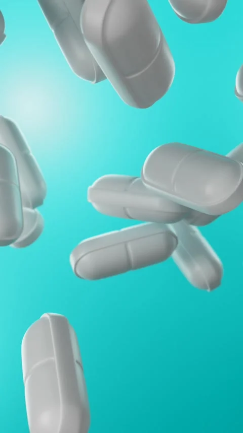  Pills falling on a blue background.  Stock Footage 265902925