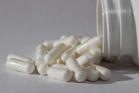 Pills falling from the bottle Stock Photos