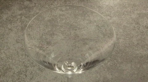 Pills falling into an empty cocktail glass Stock Footage 876643