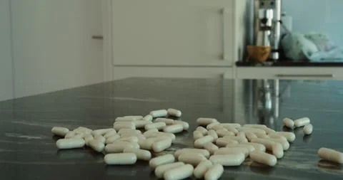 Pills Falling On Kitchen Counter Stock Footage 336387695