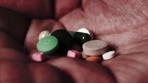 Pills falling in an open palm. Stock Footage 82877600