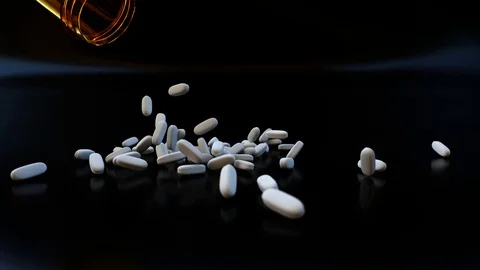 Pills Falling Out Of Bottle In Slow Motion in 4K Stock Footage