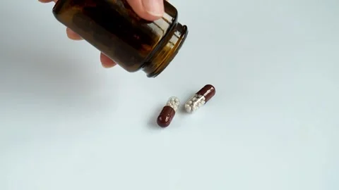 Pills falling out from a pharmacy bottle. Stock Footage 271616991