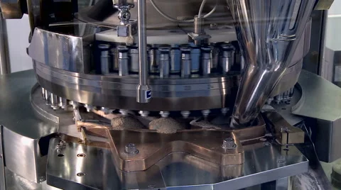 Pills falling out of pill manufacturing machine. Stockbeeldmateriaal 67413503