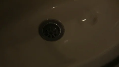 Pills falling in to a sink at night. Stock Footage 99607350