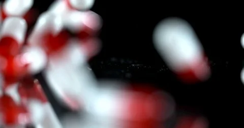 Pills falling in slow motion Stock Footage 84000146