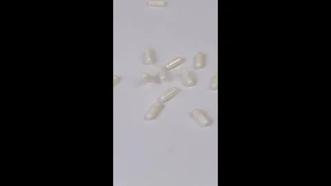 Pills Falling in Slow Motion Stock Footage 302396657