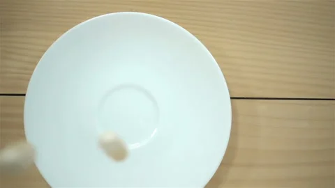 Pills falling in slow motion on plate Video stock 137787925
