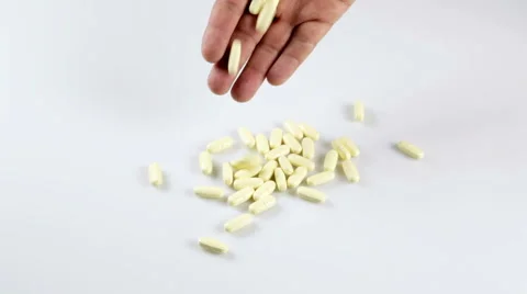 Pills falling on the table Видео 41853527