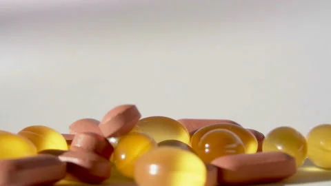 Pills falling on white background top view in slow motion Stock Footage 85628708