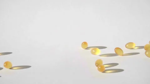 Pills falling on white background top view in slow motion Stock Footage 85631902