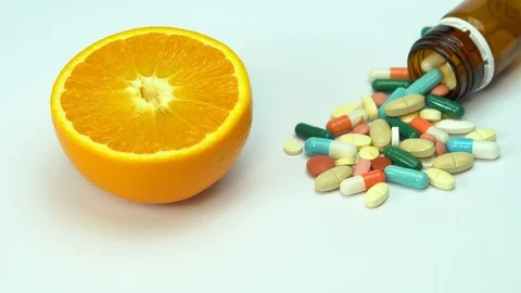 Pills with fresh fruit in background isolated Stock Footage 88469938