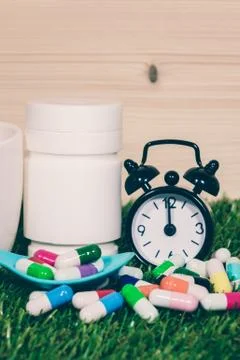 Pills on grass background Stock Photos