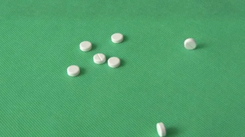 Pills on green background Video stock 59115725