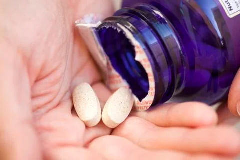 Pills in hand Stock Photos