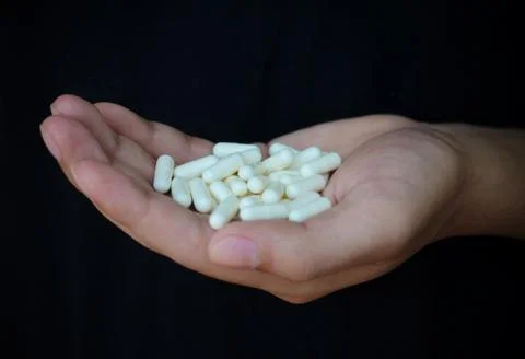 Pills in hand Stock Photos