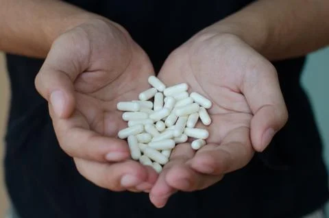 Pills in hand Stock Photos