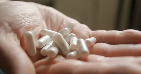 Pills in hand slow motion 4K Stock Footage 103493639