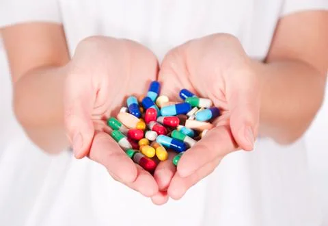 Pills in hands Stock Photos
