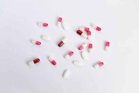 Pills highlight message. Red and white pills spread out. Empty space accentuates Stock Photos