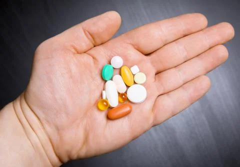 Pills on human hand Stock Photos