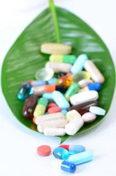 Pills on a leaf Stock Photos