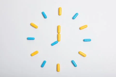 Pills on a light background top view. Medicine, treatment, illness. Stock Photos