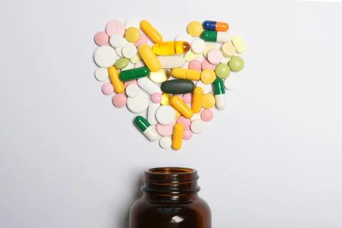 Pills on a light background top view. Medicine, treatment, illness. Stock Photos