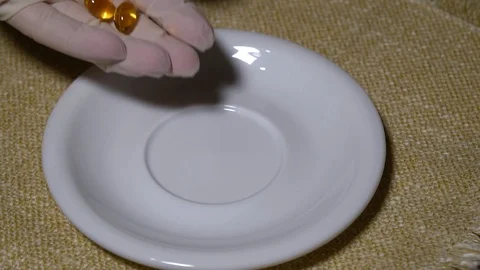 Pills. Medication closeup. Closeup hand puts multicolored pills and capsules on Stock Footage 99441340
