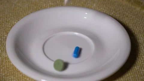 Pills. Medication closeup. A pile of multi-colored pills is slowly falling on a Video stock 99439314