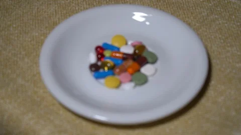 Pills. Medication closeup. A pile of multi-colored tablets lies on a white Video stock 99462228