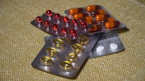Pills. Medicine closeup. Blisters with multi-colored pills and capsules lie on a Stock Footage 99463538