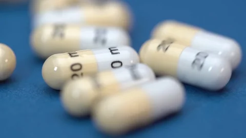 Pills micro move on blue background Video stock 127761375