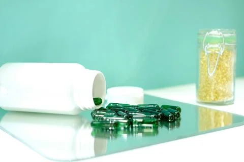 Pills on a mirror Stock Photos