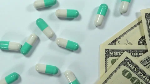 Pills next to dollar bills Stock Footage 171413834