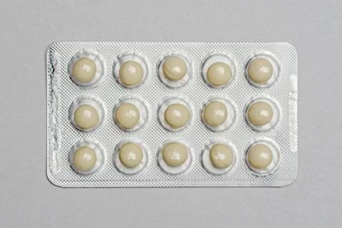 Pills in a pack on gray paper background Stock Photos