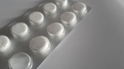 Pills in a package on a white background Stock Photos