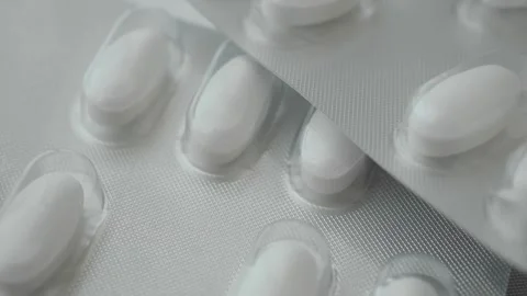 Pills in packaging on a flat surface with close up view Stock Footage 336474279