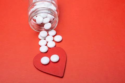 Pills poured from a jar on a red background Stock Illustration