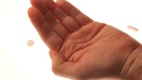 Pills pouring into an open hand. Stock Footage 132716516