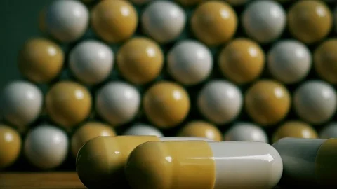 Pills in pyramid shape on dollar bill background Stock Footage 125518744