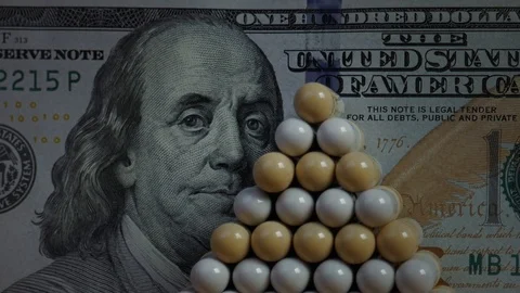 Pills in pyramid shape on dollar bill background Stock Footage 125518896