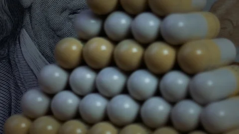 Pills in pyramid shape on dollar bill background Stock Footage 125519414
