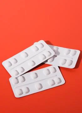 Pills on red background Stock Photos