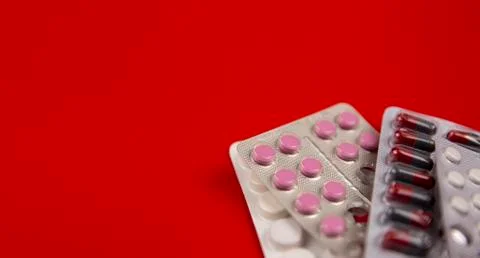 Pills on a red background Stock Photos