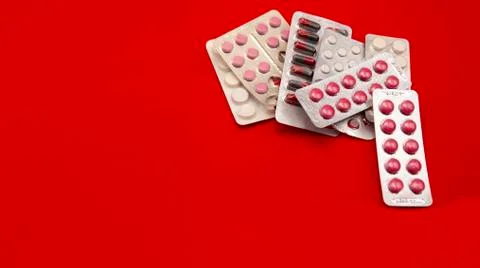 Pills on a red background Stock Photos