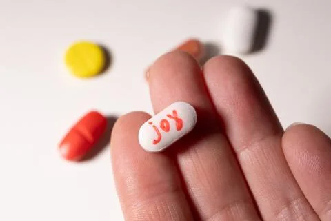 Pills Representing Joy in a Hand Showcase the Struggle With Addiction and Mental Stock Photos