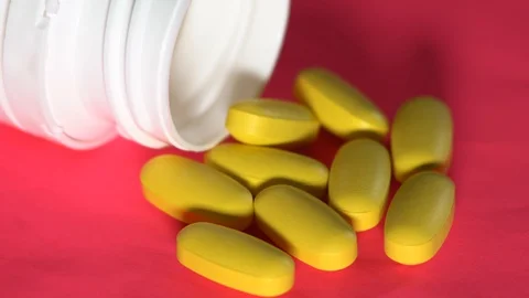 Pills rotate on pink background. Stock Footage 88362302