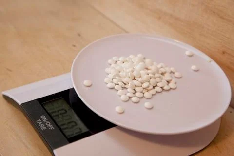 Pills on a scale Stock Photos