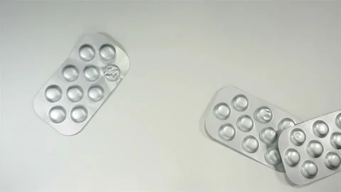 Pills in silver blisters fall in 4K Video stock 143416658